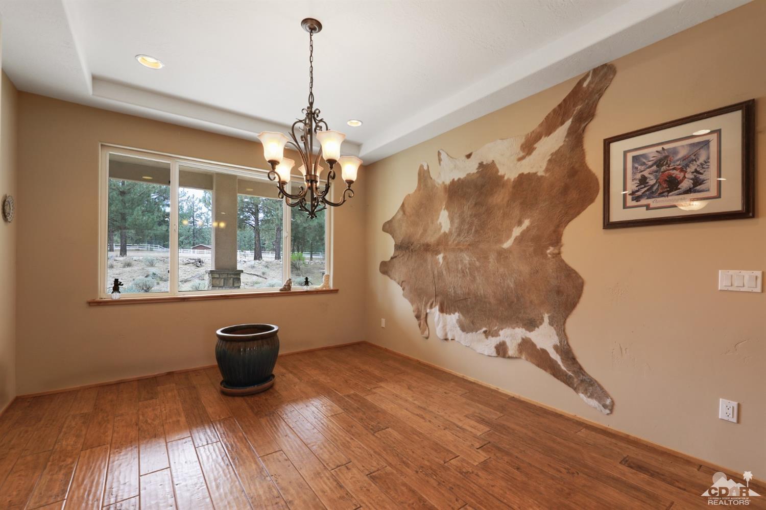 59870 Devils Ladder Road Mountain Center, CA 92561 - Photo 7 of 31 a view of a room with a large window and wooden floor