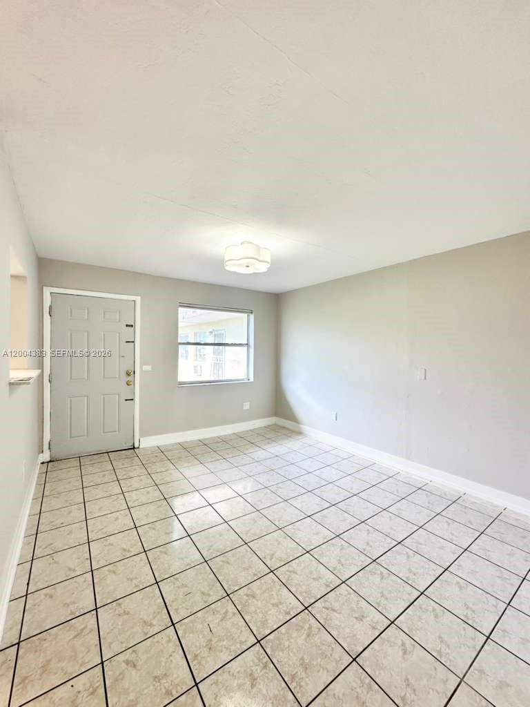 2651 Northwest 13th Street, Unit 41 Miami, FL 33125 - Photo 2 of 10 a view of an empty room and window