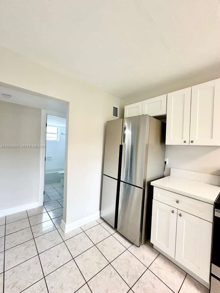 2651 Northwest 13th Street, Unit 41 Miami, FL 33125 - Photo 3 of 10 a kitchen with a refrigerator sink and cabinets