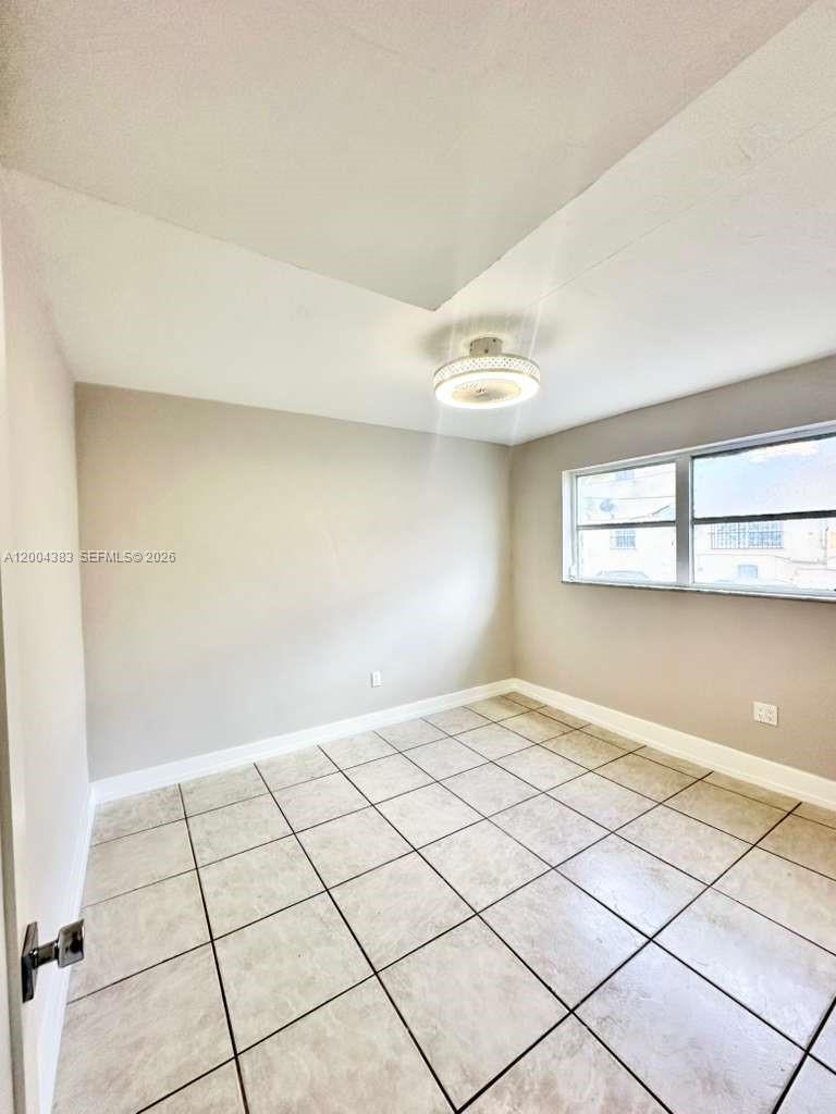 2651 Northwest 13th Street, Unit 41 Miami, FL 33125 - Photo 5 of 10 a view of an empty room and window