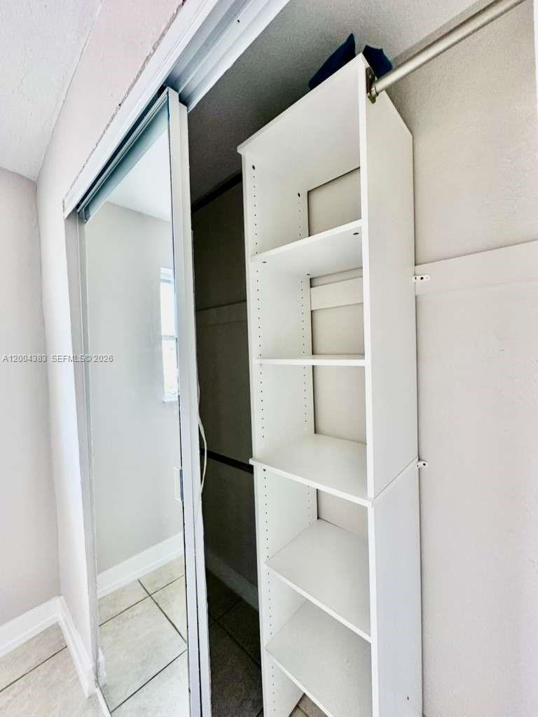 2651 Northwest 13th Street, Unit 41 Miami, FL 33125 - Photo 6 of 10 a view of walk in closet with empty racks