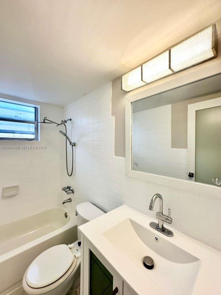 2651 Northwest 13th Street, Unit 41 Miami, FL 33125 - Photo 8 of 10 a bathroom with a sink toilet and shower