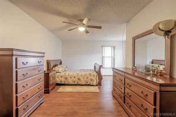 a spacious bedroom with a bed and a chandelier