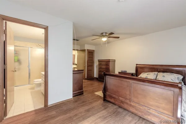 a view of a kitchen with furniture and wooden floor