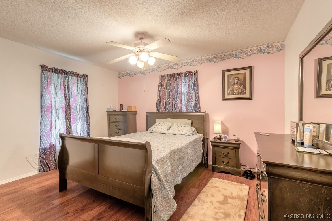 2804 Mango Tree Drive Edgewater, FL 32141 - Photo 14 of 29 a bed room with a bed and a chandelier
