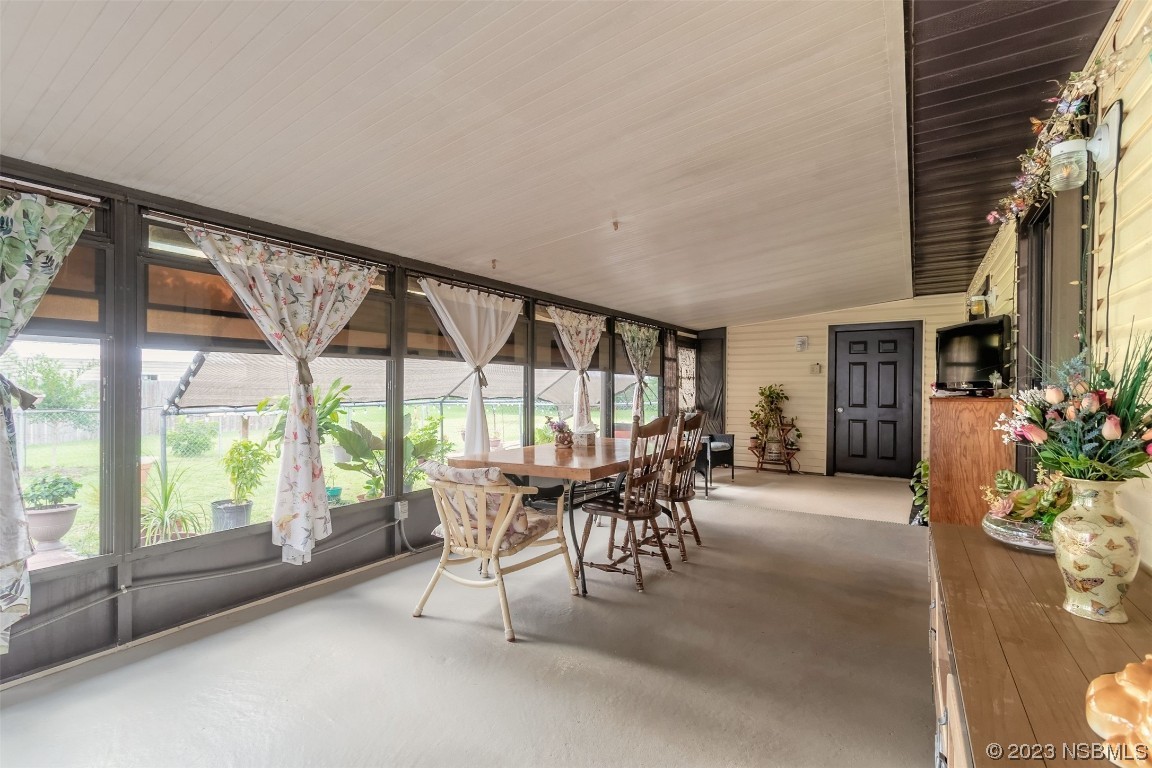 2804 Mango Tree Drive Edgewater, FL 32141 - Photo 23 of 29 a dining room with furniture and garden view
