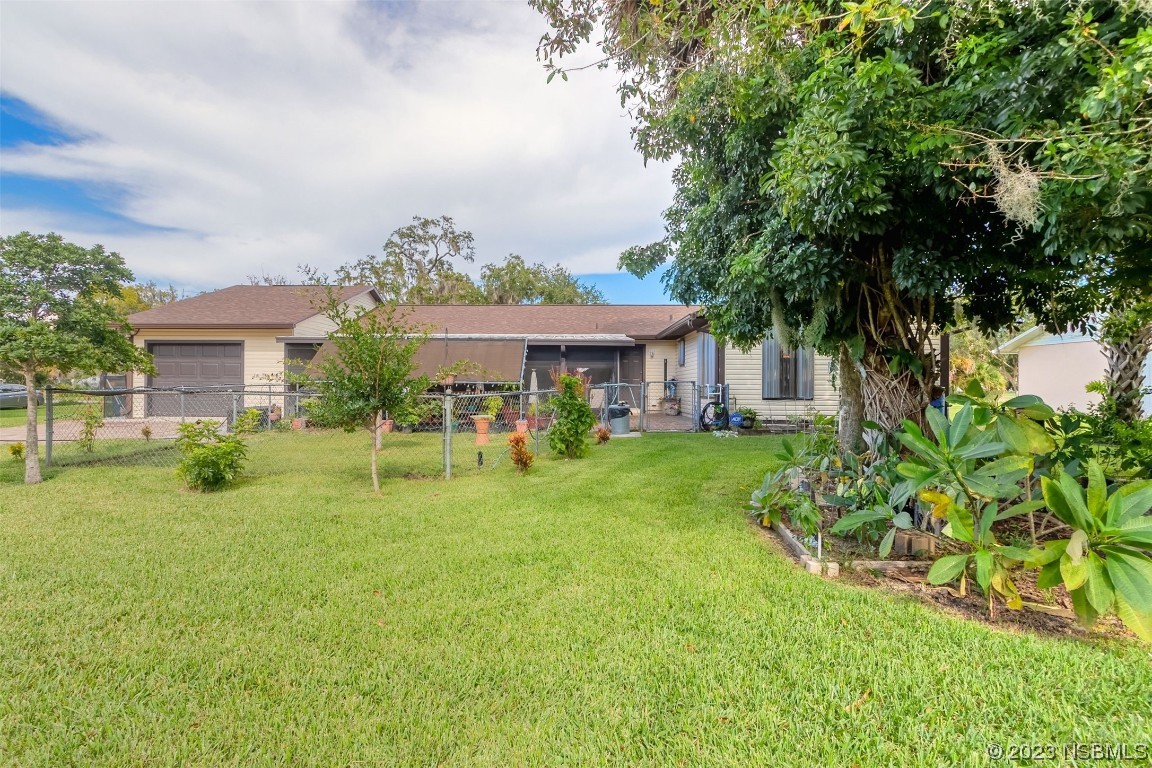 2804 Mango Tree Drive Edgewater, FL 32141 - Photo 25 of 29 a front view of a house with a yard