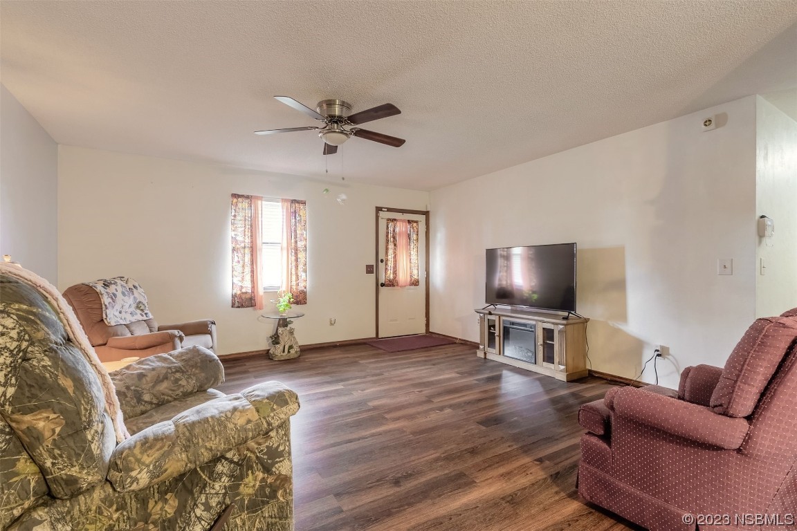 2804 Mango Tree Drive Edgewater, FL 32141 - Photo 3 of 29 a living room with furniture a window and a flat screen tv