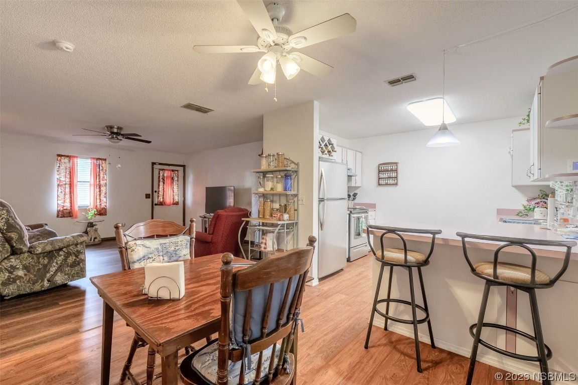 2804 Mango Tree Drive Edgewater, FL 32141 - Photo 6 of 29 a view of a dining room with furniture and wooden floor