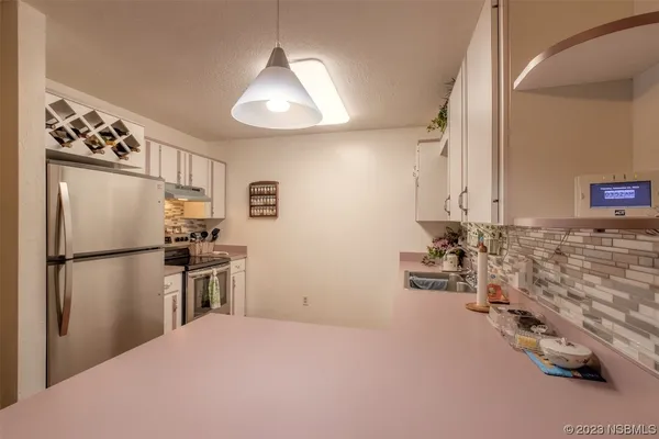 a kitchen with granite countertop a refrigerator and a stove