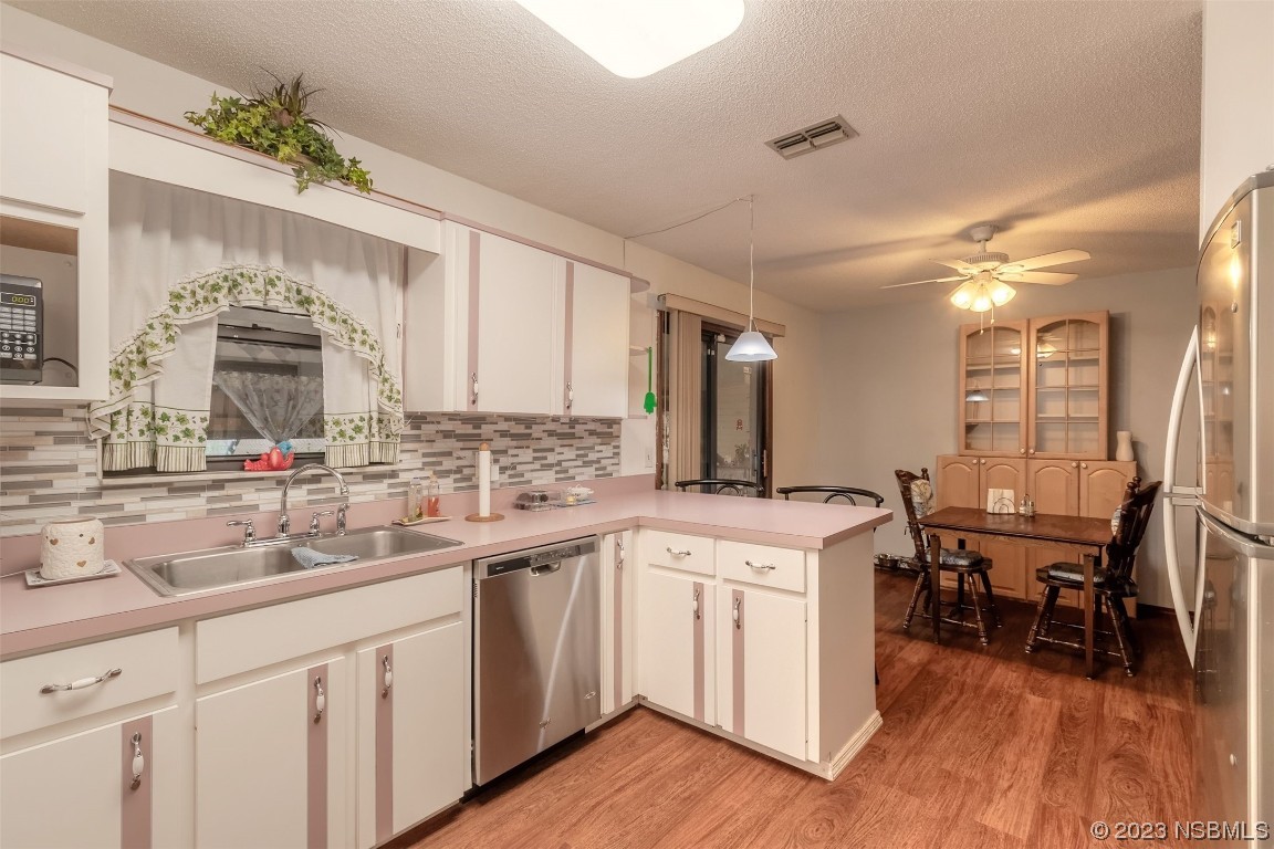 2804 Mango Tree Drive Edgewater, FL 32141 - Photo 10 of 29 a kitchen with a sink cabinets and wooden floor