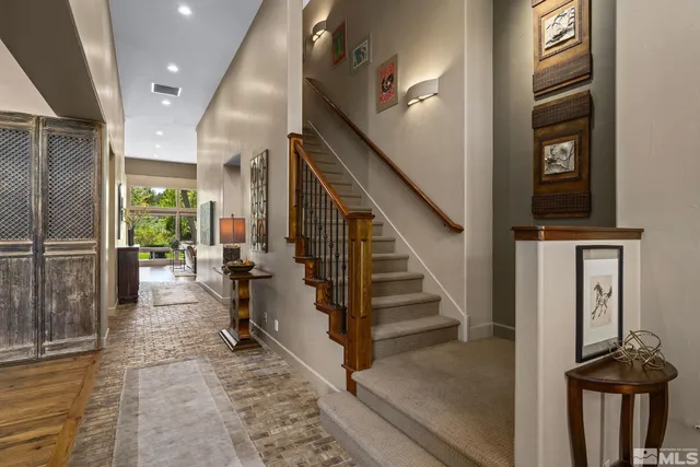 a view of entryway and hall with wooden floor