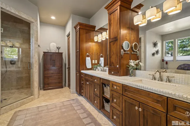 a spacious bathroom with a shower sink and mirror
