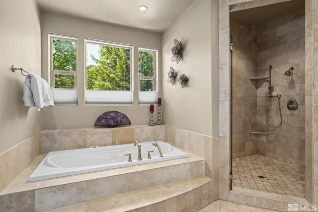 a bathroom with a bathtub and a shower