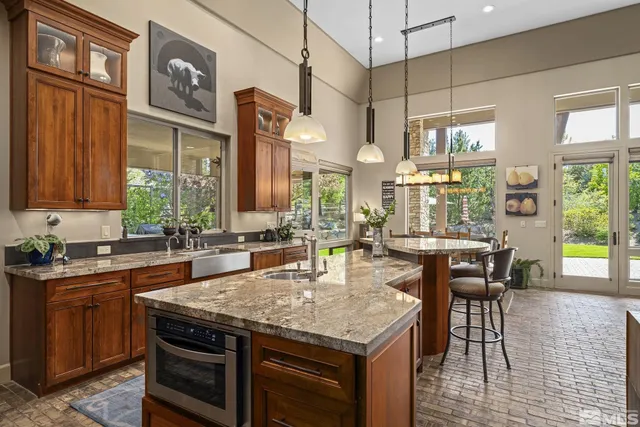a kitchen with stainless steel appliances granite countertop stove top oven and cabinets