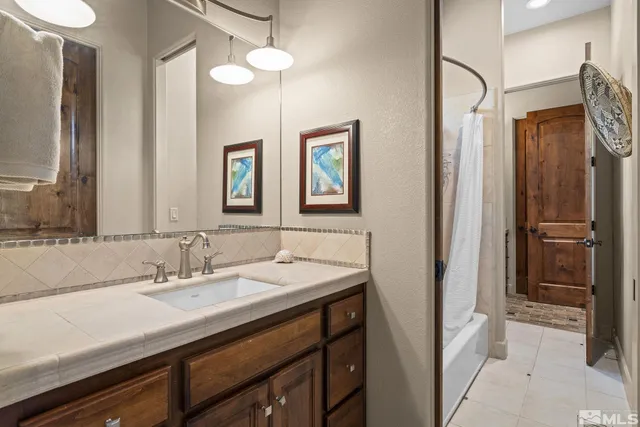 a bathroom with 2 sink and a mirror