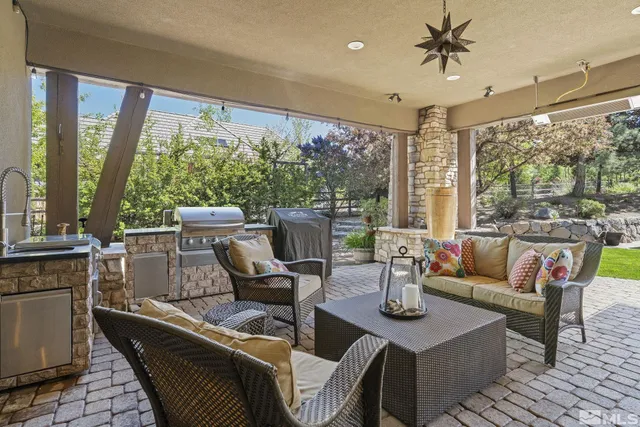a living room with furniture and large windows