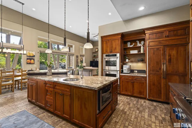 a kitchen with stainless steel appliances granite countertop a sink and cabinets