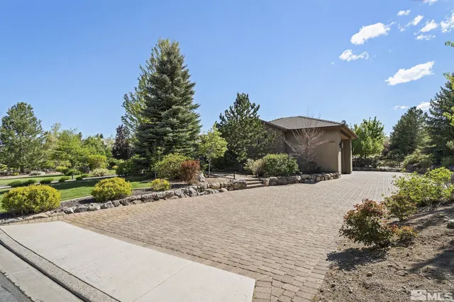a pathway of a house with a yard and basket ball court