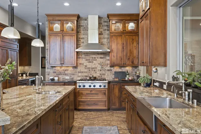 a kitchen with granite countertop a sink stove and cabinets