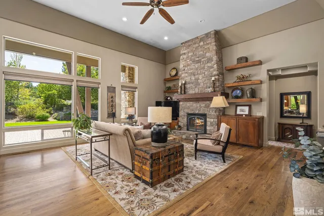 a living room with fireplace furniture and a large window