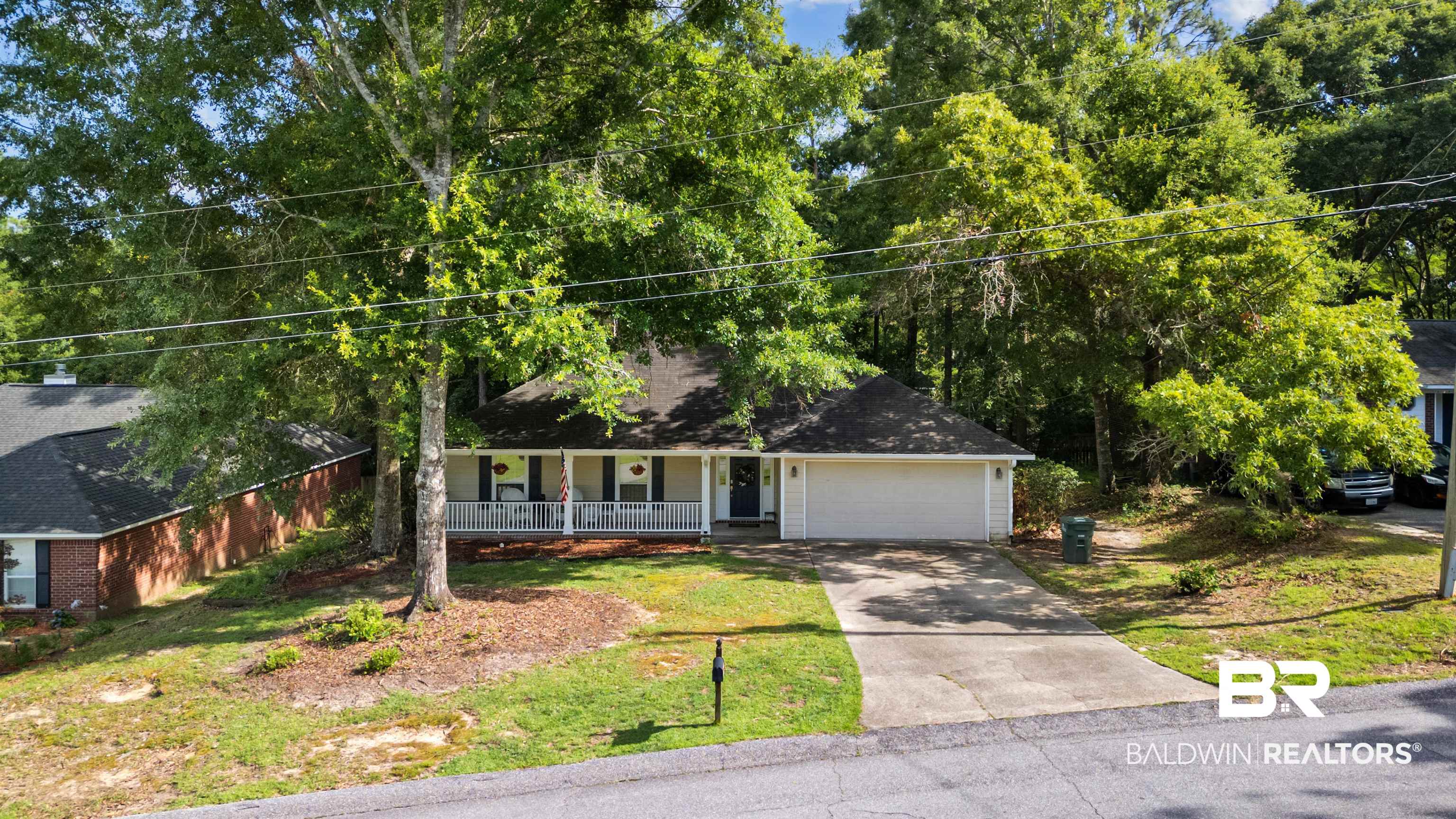 153 Lakeview Loop Daphne, AL 36526 - Photo 2 of 56 Nestled beneath a canopy of established trees, this property offers a peaceful setting while remaining close to everything Daphne has to offer.