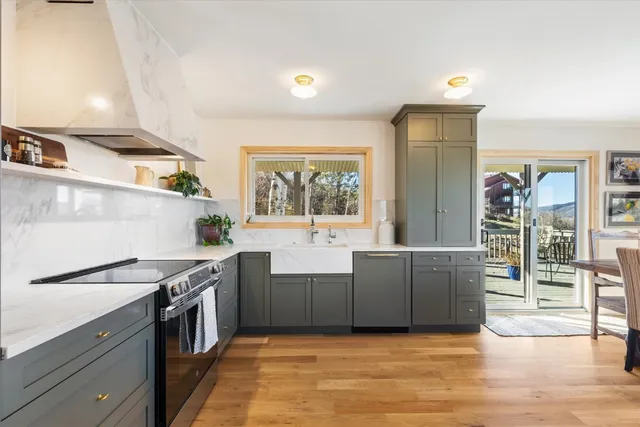 a kitchen with stainless steel appliances granite countertop a stove a sink and a refrigerator