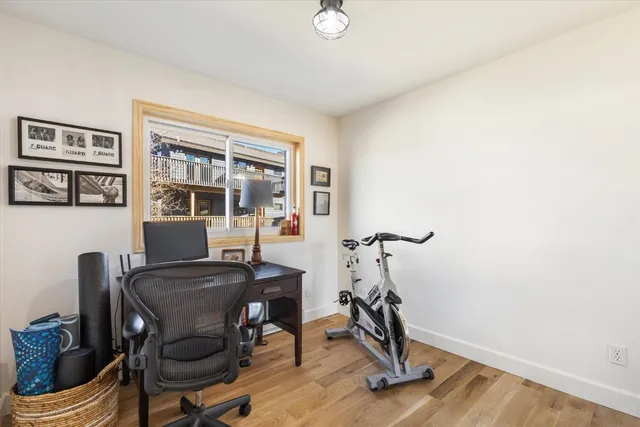 a view of workspace room with furniture and wooden floor
