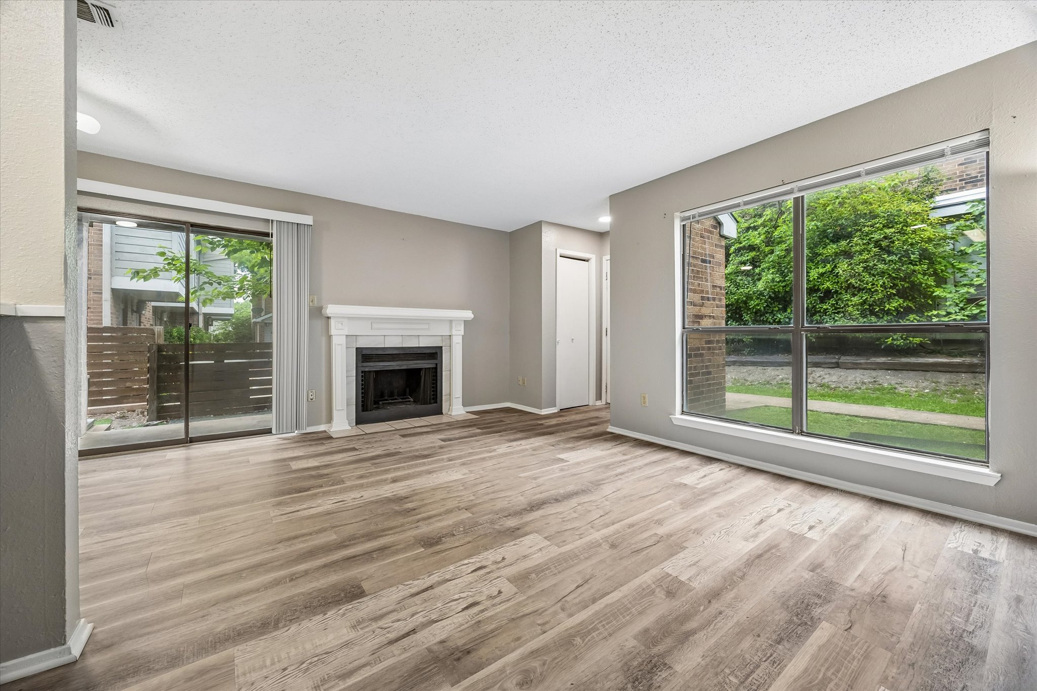 2018 West Rundberg Lane, Unit 13A Austin, TX 78758 - Photo 3 of 11 a view of an empty room with wooden floor and a window