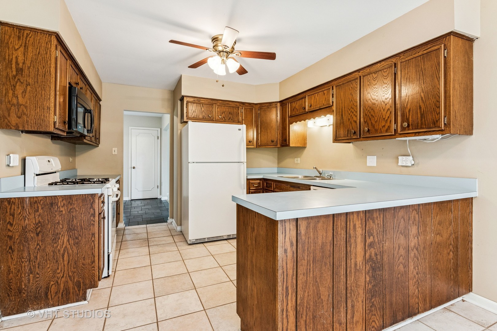 1490 Briar Cove Wheaton, IL 60189 - Photo 7 of 22 a kitchen with a sink a refrigerator and cabinets