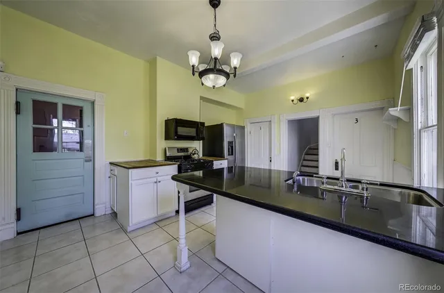 a kitchen with a sink cabinets and window