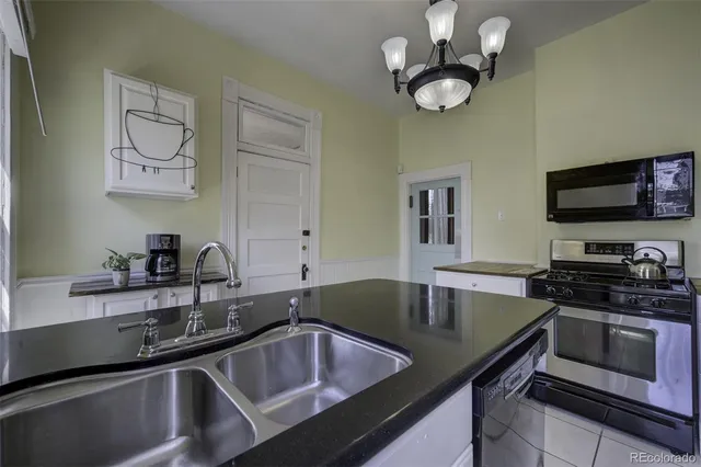 a kitchen with a sink cabinets and stainless steel appliances