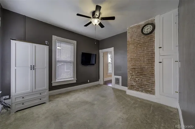 a view of an empty room with a ceiling fan