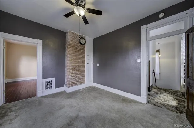 a view of an empty room with a ceiling fan