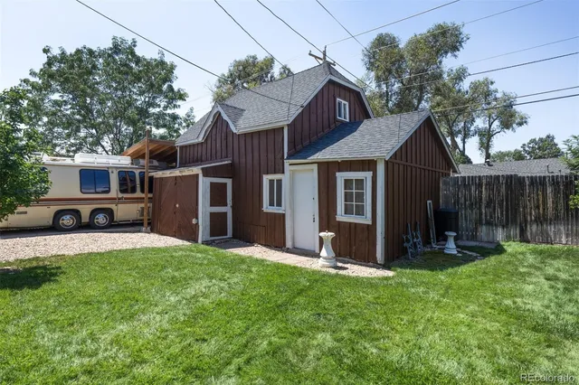 a view of a house with a yard and sitting area
