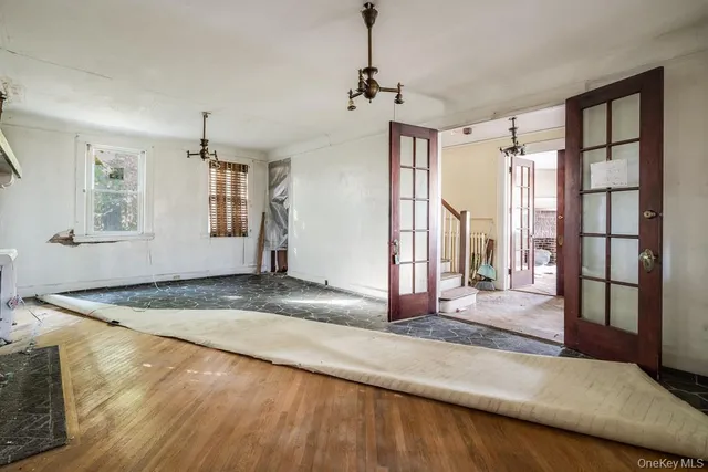 a view of a livingroom with wooden floor and a window