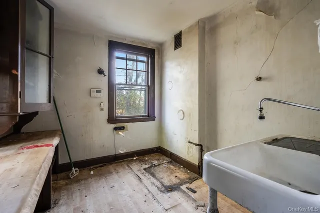 a bathroom with a tub sink and a window