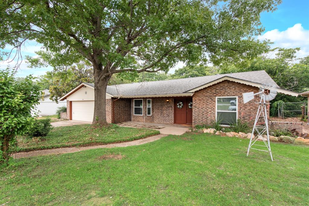 926 Meadowbrook Drive Grapevine, TX 76051 - Photo 1 of 1 a front view of house with a garden and trees