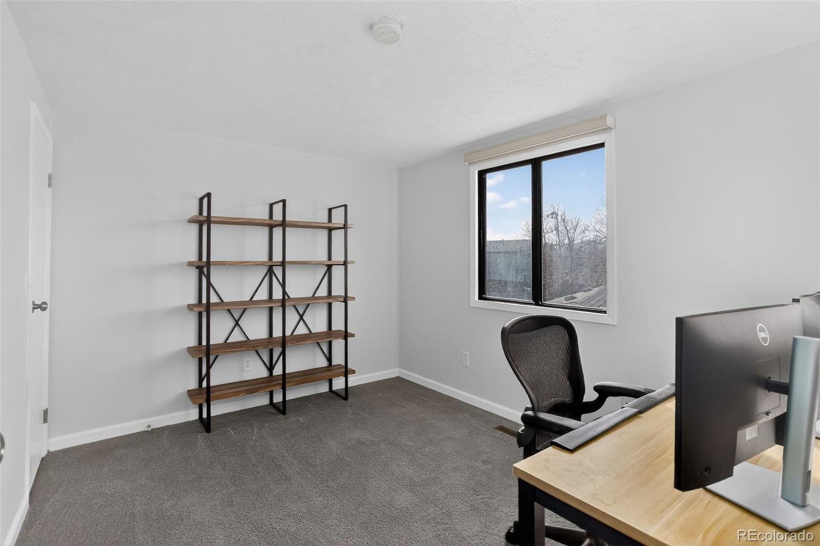 9404 Pierce Street Broomfield, CO 80021 - Photo 11 of 20 a view of a workspace with furniture and a window