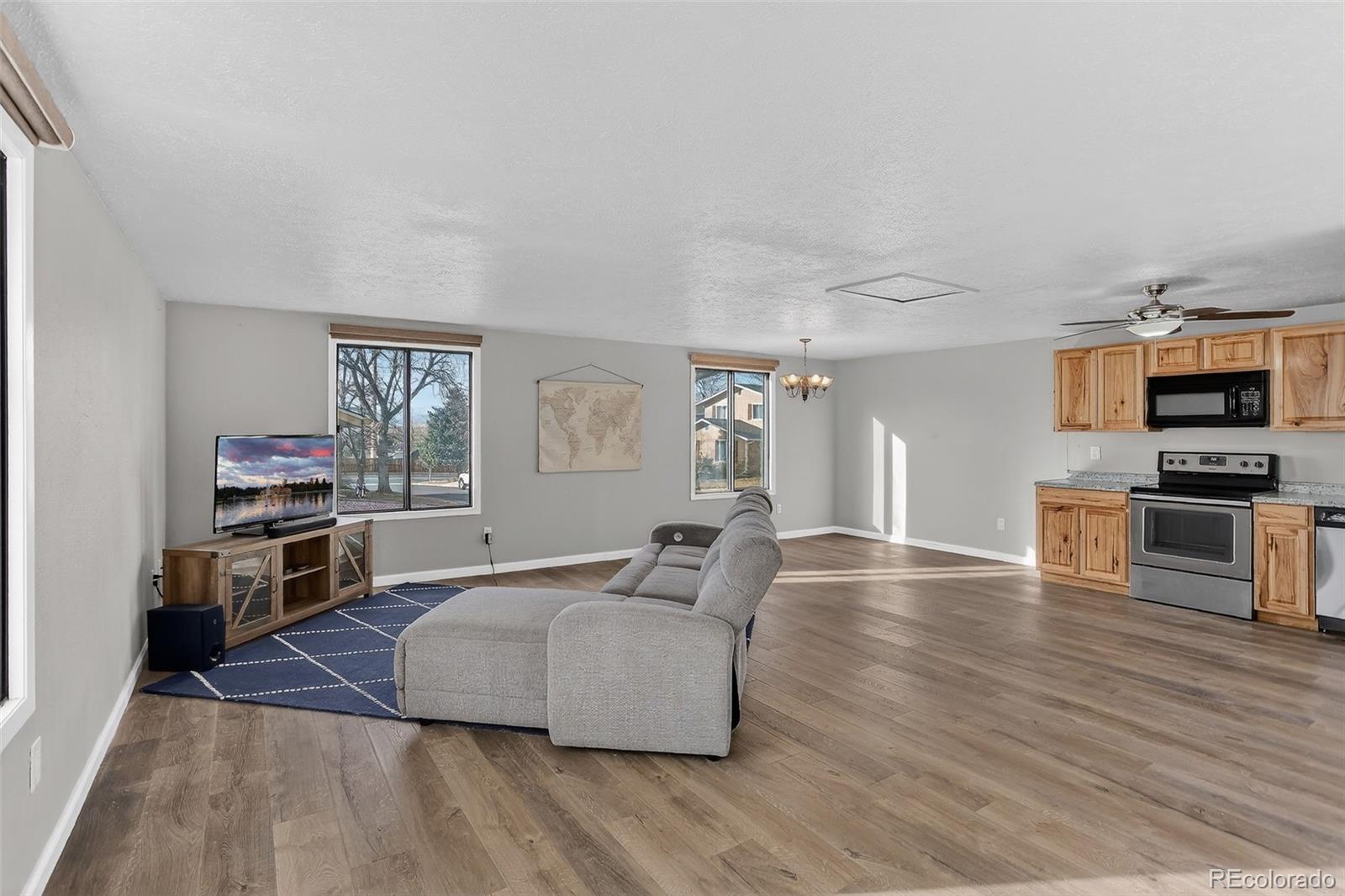 9404 Pierce Street Broomfield, CO 80021 - Photo 2 of 20 a living room with furniture and a wooden floor