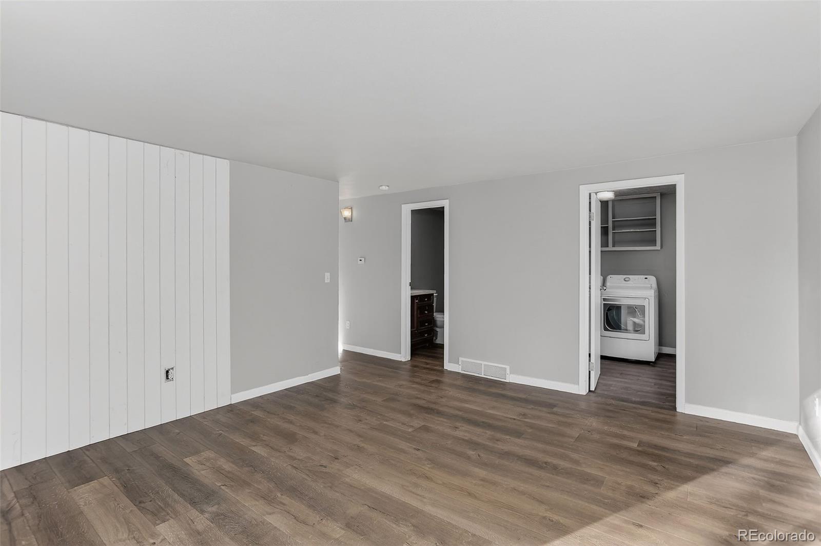 9404 Pierce Street Broomfield, CO 80021 - Photo 6 of 20 a view of an empty room with wooden floor and closet