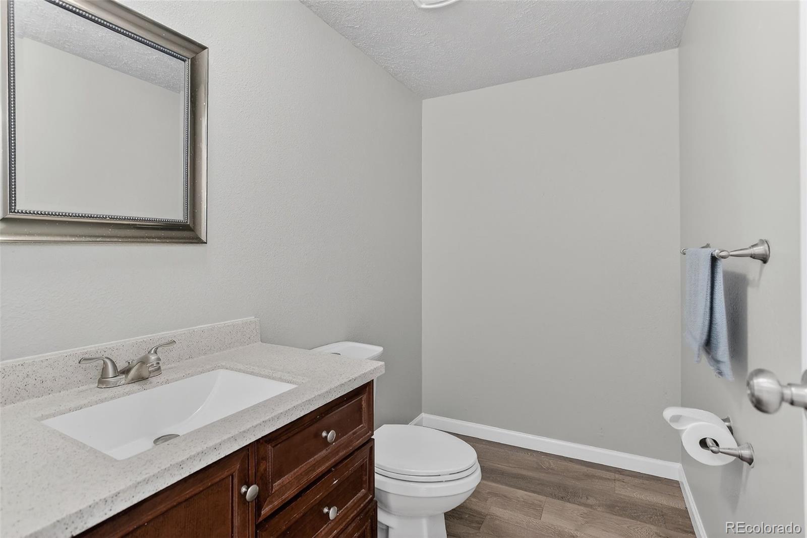 9404 Pierce Street Broomfield, CO 80021 - Photo 7 of 20 a bathroom with a granite countertop sink toilet and mirror