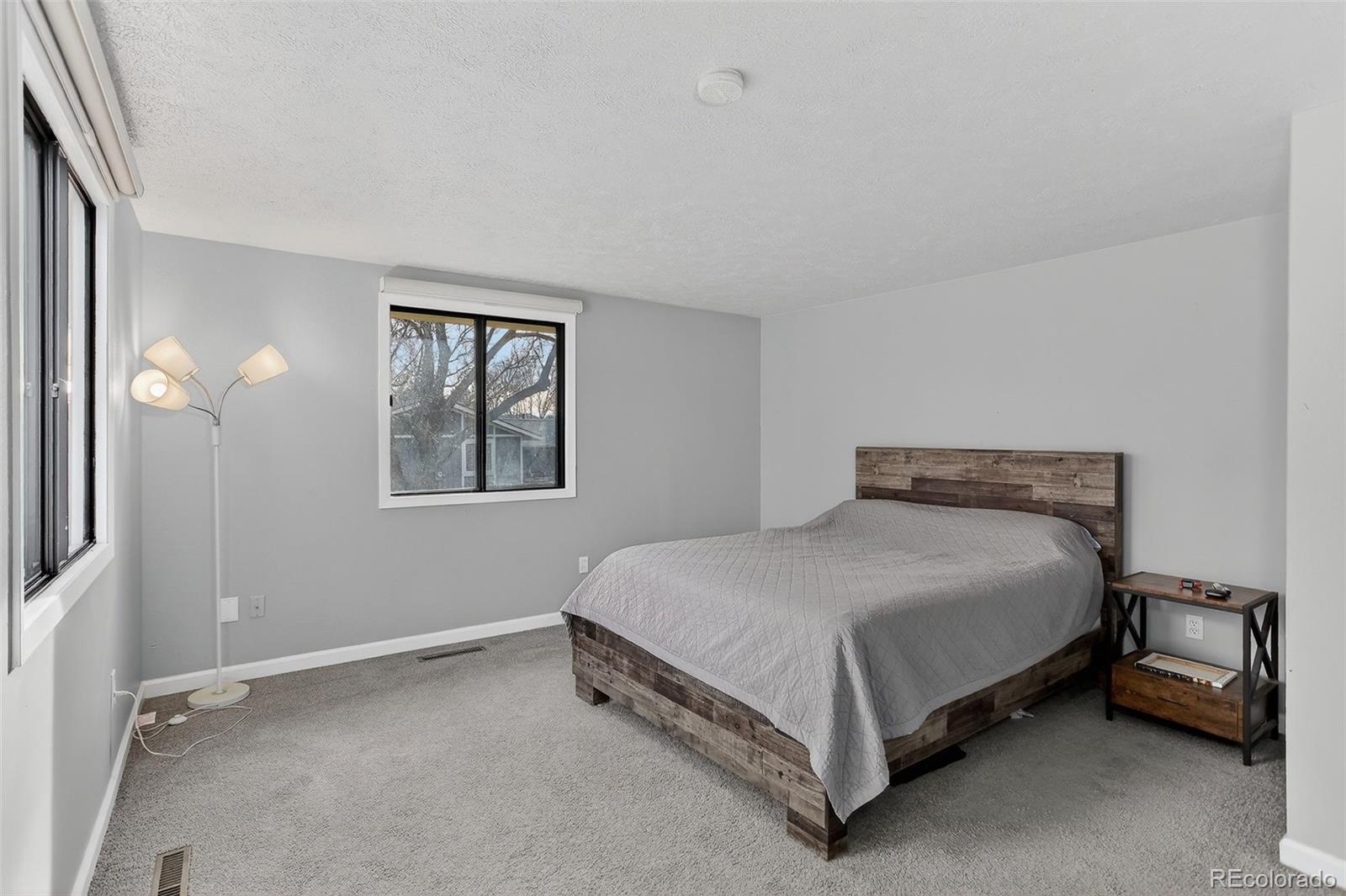 9404 Pierce Street Broomfield, CO 80021 - Photo 8 of 20 a bed sitting in a bedroom next to a window