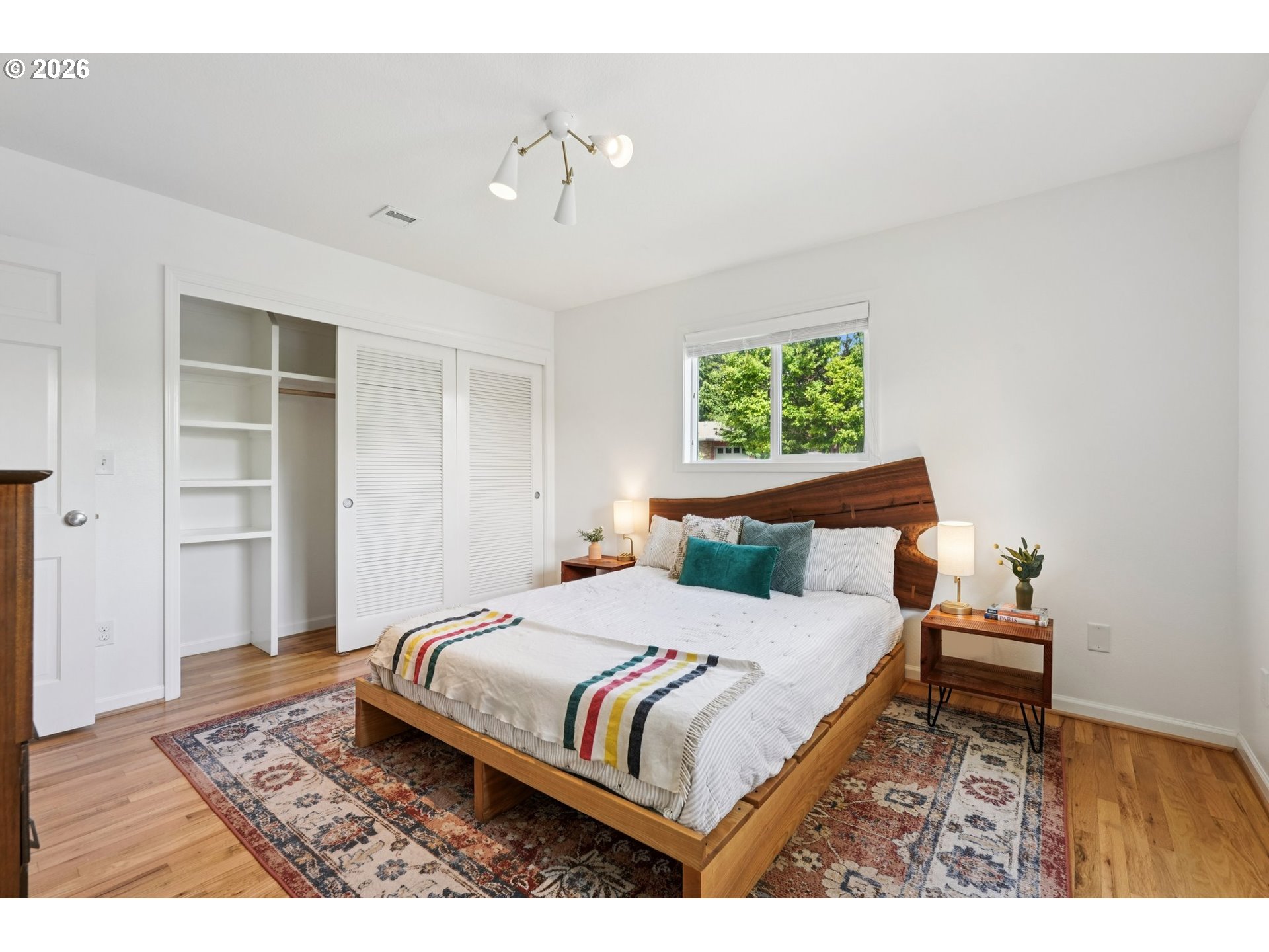 7225 Southwest 13th Avenue Portland, OR 97219 - Photo 21 of 48 a bedroom with a bed and a chandelier