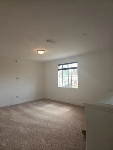 an empty room with a empty space and windows