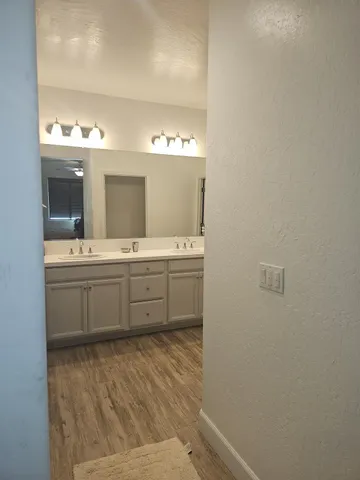 a bathroom with a double vanity sink and mirror