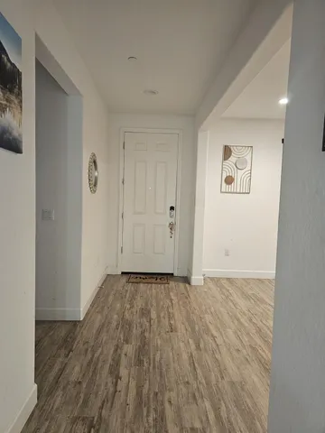 a view of an empty room and wooden floor