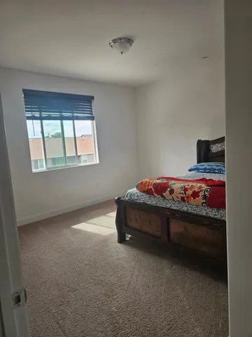 a bedroom with bed and window