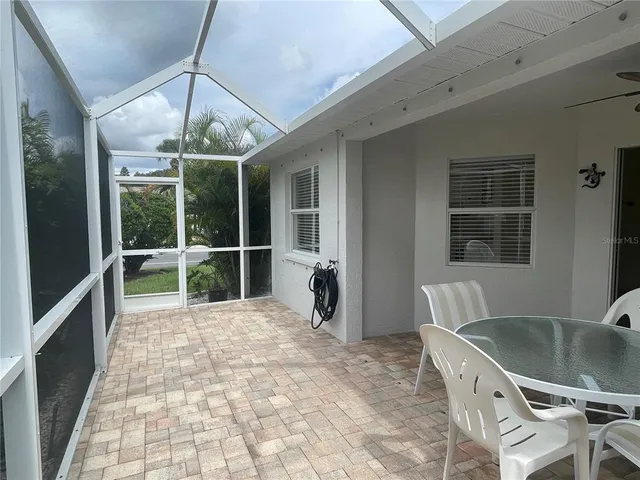 a view of a porch with furniture and floor to ceiling window