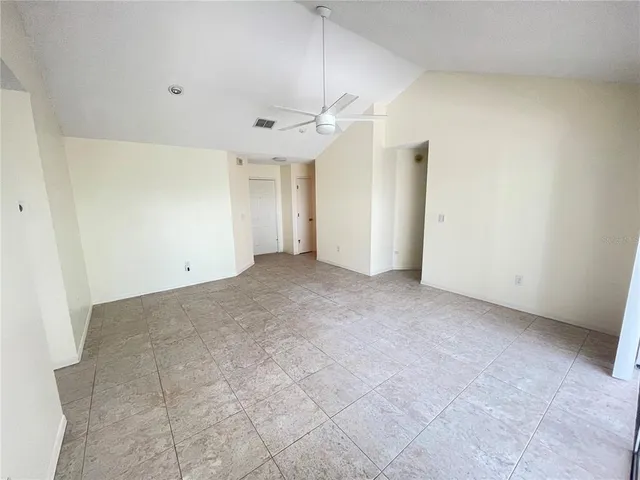 a view of an empty room with a ceiling fan